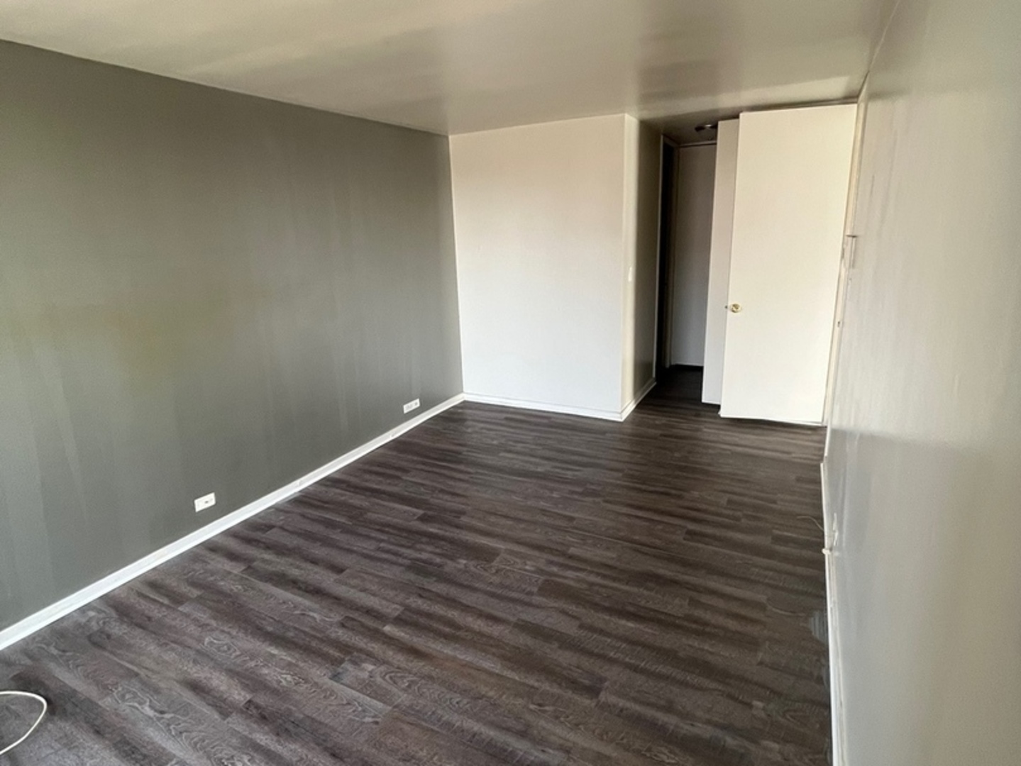2605 South Indiana Avenue, Unit 301 Chicago, IL 60616 - Photo 12 of 23 a view of an empty room with wooden floor