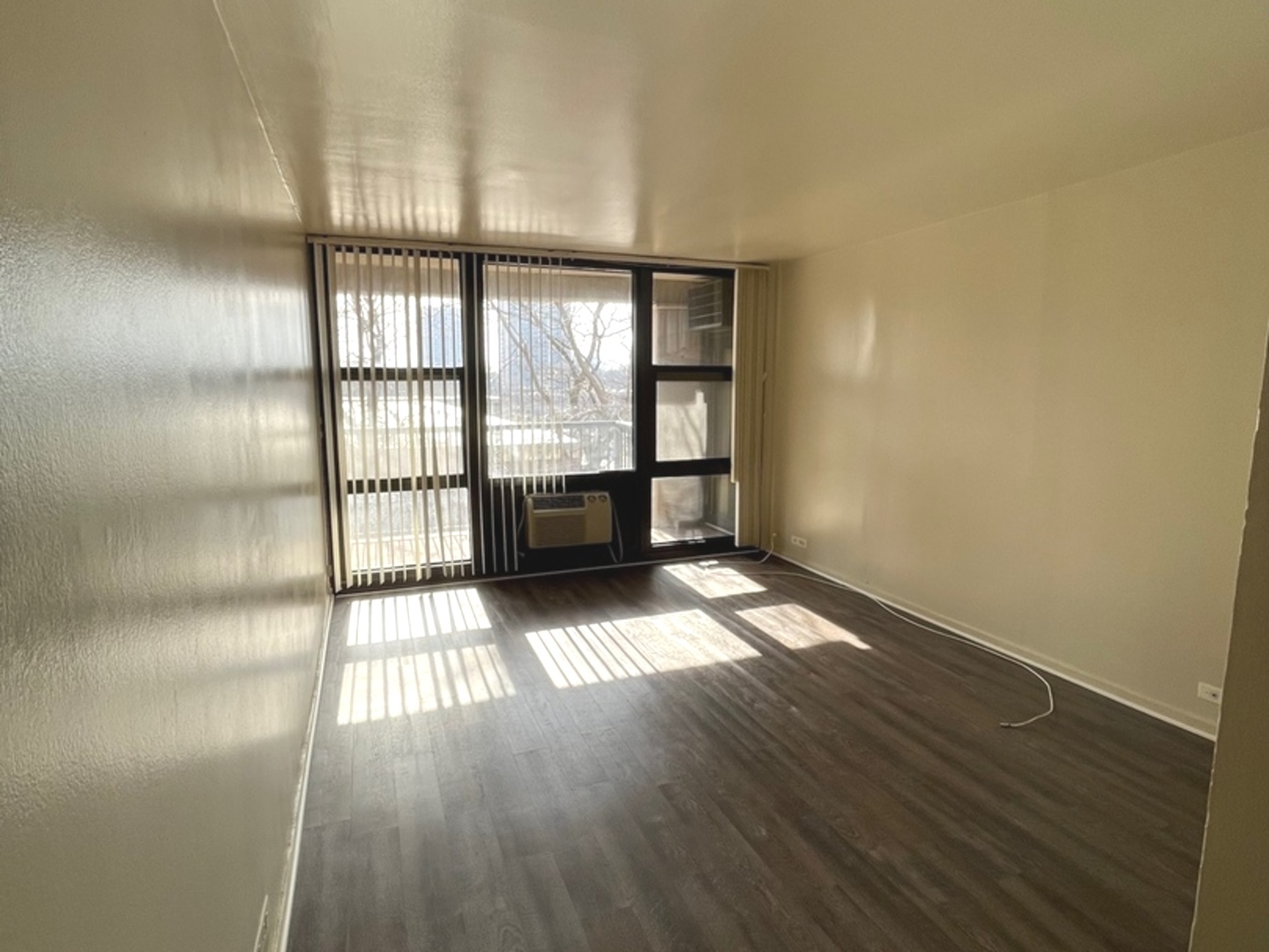 2605 South Indiana Avenue, Unit 301 Chicago, IL 60616 - Photo 16 of 23 wooden floor in an empty room with a window