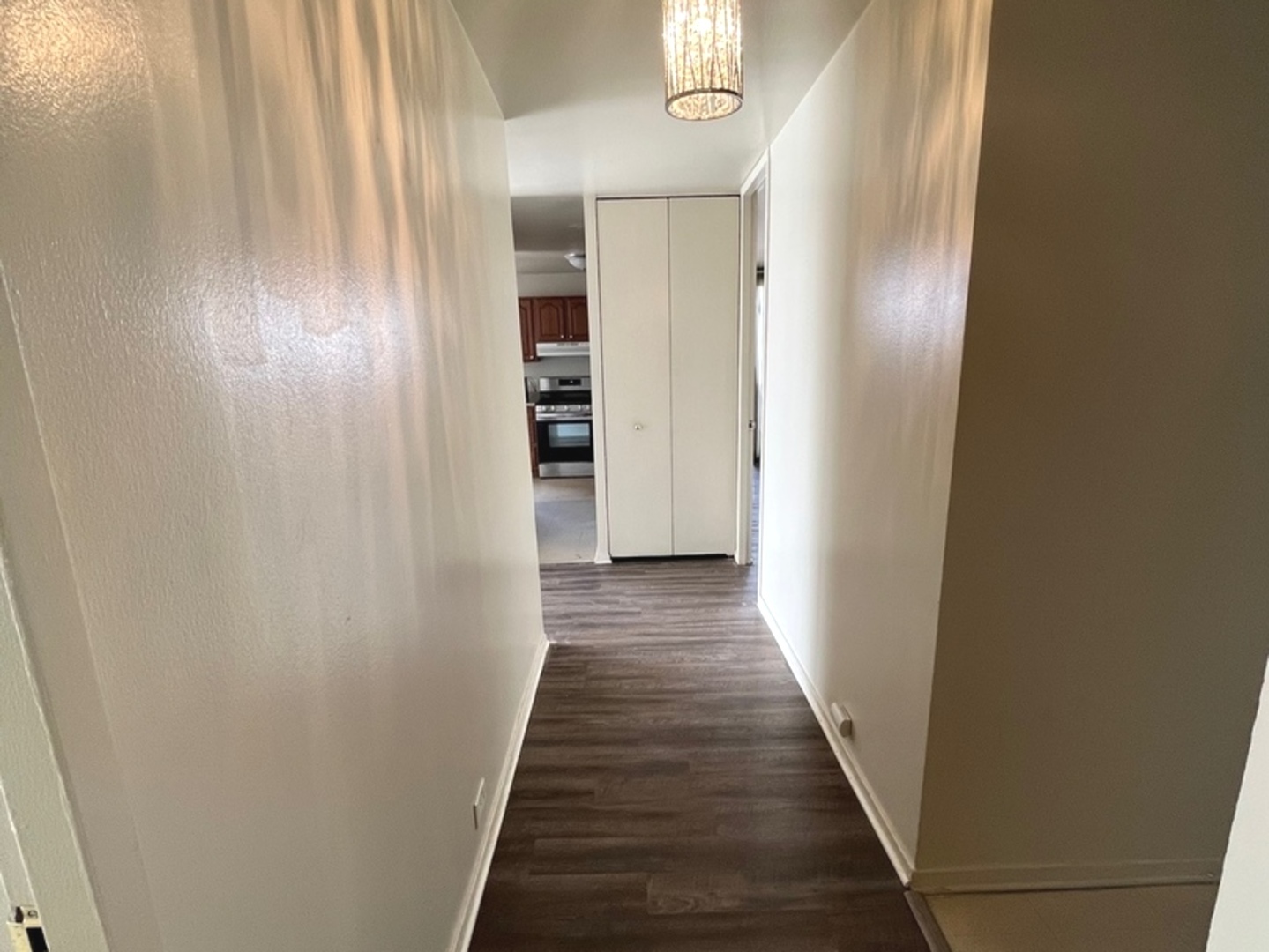 2605 South Indiana Avenue, Unit 301 Chicago, IL 60616 - Photo 17 of 23 a view of a hallway with wooden floor and staircase