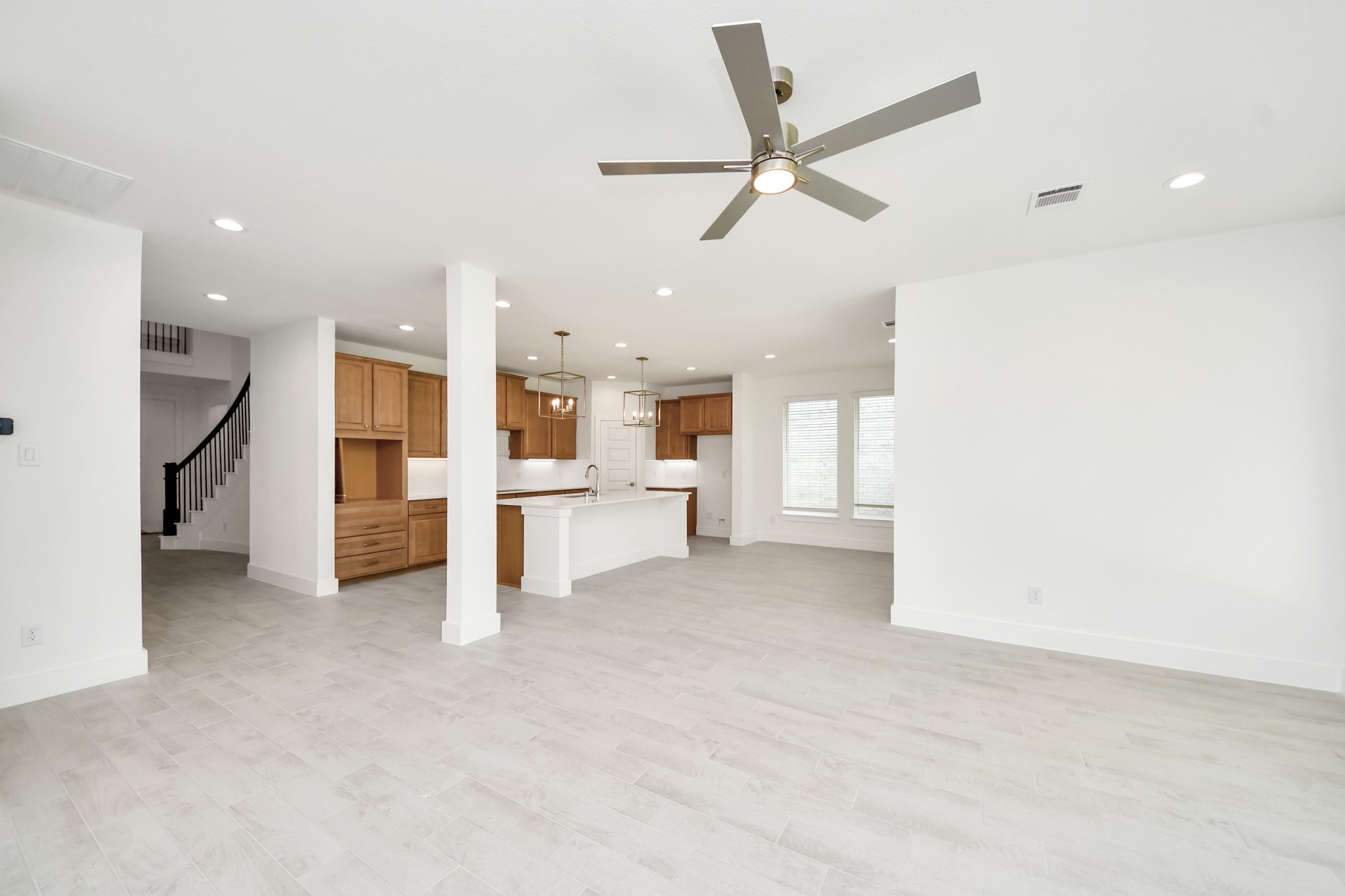 3102 Native Spg Drive Spring, TX 77373 - Photo 20 of 47 Family room flooded with natural light through the expansive windows. The premium tile flooring adds a touch of luxury to the space, creating the perfect setting for relaxing moments and cherished gatherings with loved ones.