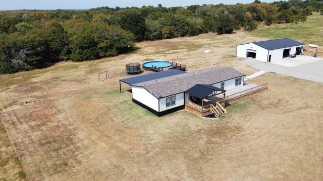 36469 1330th Road Wewoka, OK 74884 - Photo 39 of 39 White exterior residence with a dark roof and an expansive wooden deck