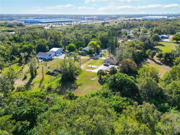 a view of a city with lush green forest