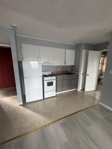 a kitchen with a stove a refrigerator and a sink