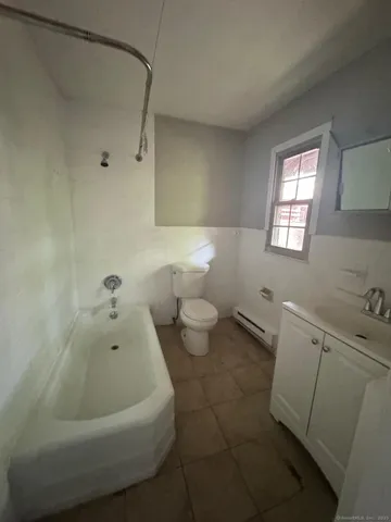 a bathroom with a bathtub and a toilet