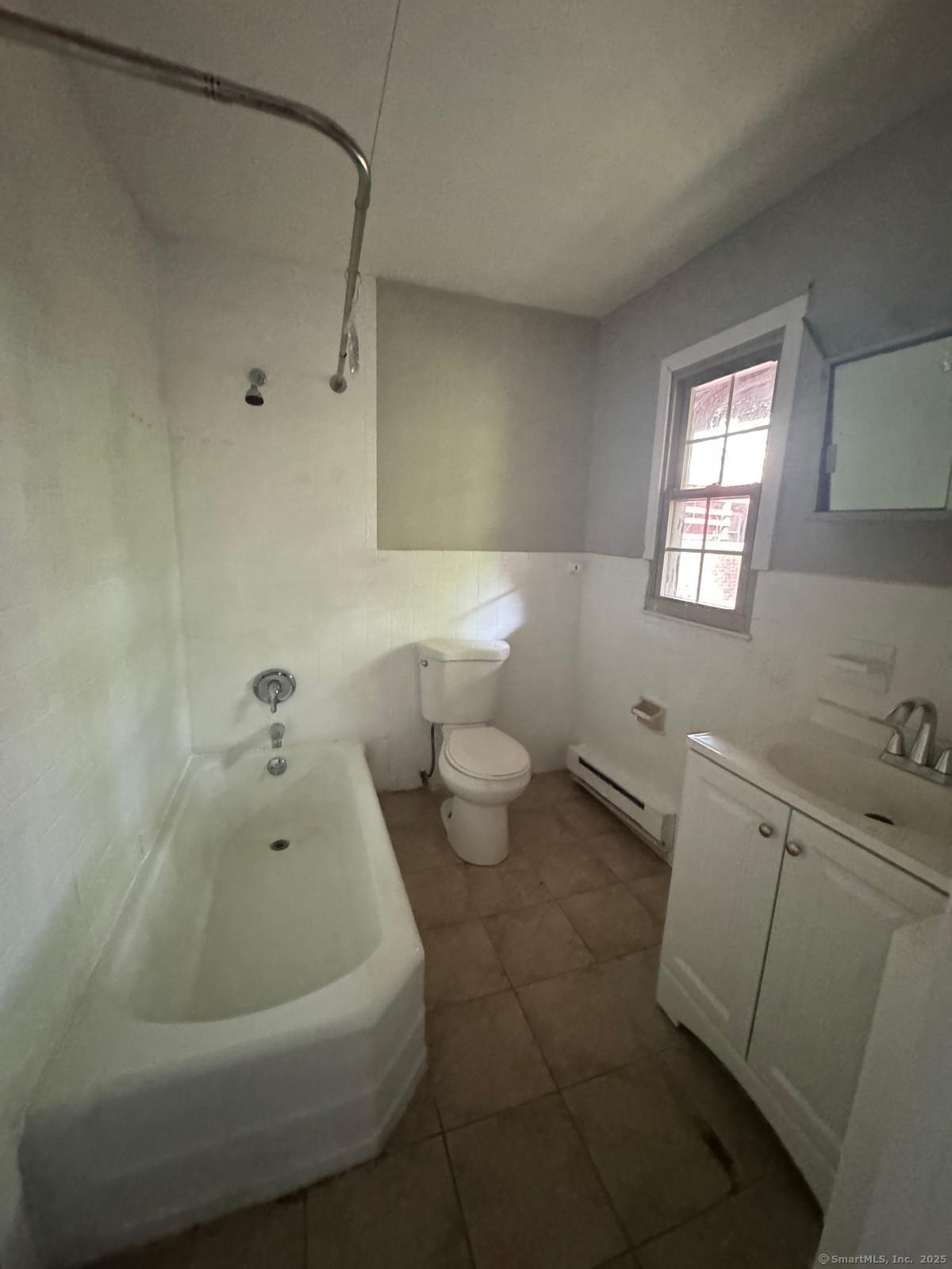 240 Oak Street, Unit 7 Bridgeport, CT 06604 - Photo 6 of 6 a bathroom with a bathtub and a toilet