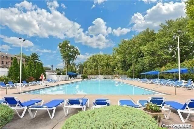1 Terrace Circle, Unit 3H Great Neck, NY 11021 - Photo 11 of 11 a view of a swimming pool and lounge chairs