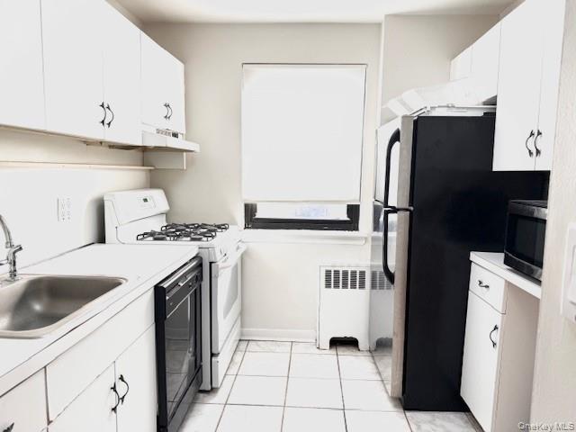 1 Terrace Circle, Unit 3H Great Neck, NY 11021 - Photo 2 of 11 a kitchen with stainless steel appliances granite countertop a sink a refrigerator and a stove