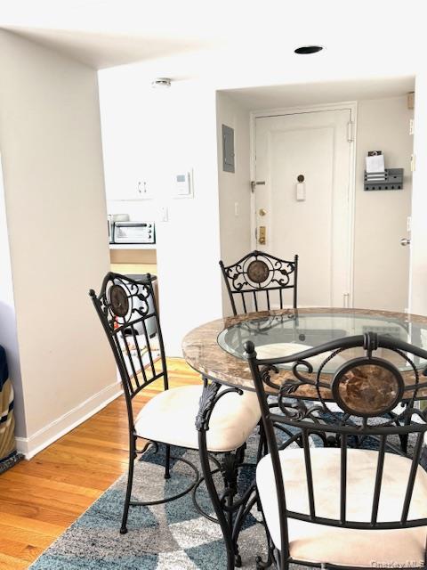 1 Terrace Circle, Unit 3H Great Neck, NY 11021 - Photo 3 of 11 a view of a dining room with furniture and wooden floor