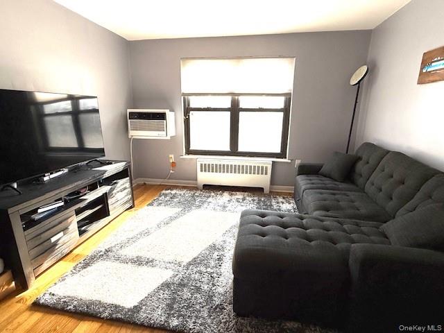 1 Terrace Circle, Unit 3H Great Neck, NY 11021 - Photo 4 of 11 a living room with furniture and a flat screen tv