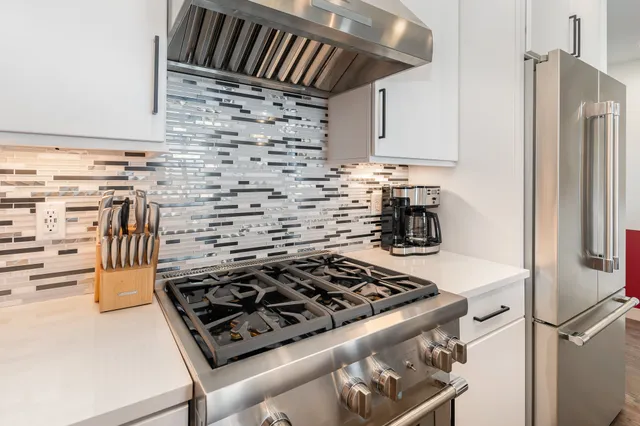 a kitchen with a stove and a refrigerator