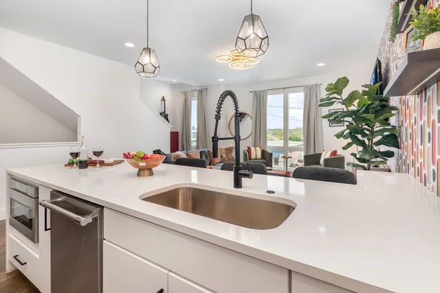 a kitchen with a sink and chandelier