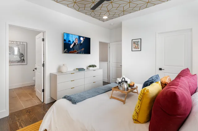 a bedroom with a bed and a flat screen tv