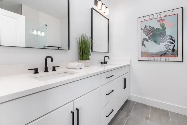 a bathroom with a double vanity sink and mirror