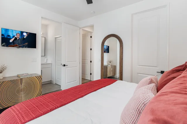 a bedroom with a bed and a flat screen tv