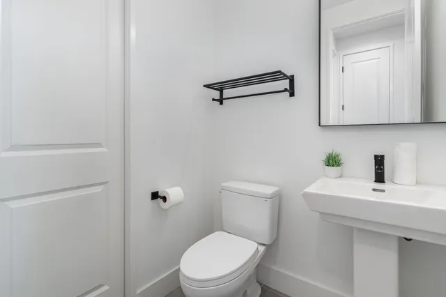 a white toilet sitting next to a bathroom sink