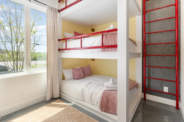 a bedroom with a bed and a window