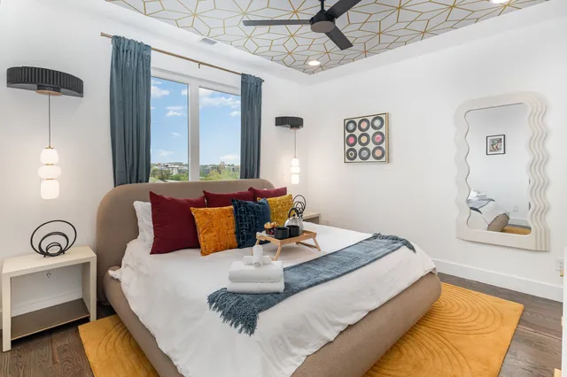 a bed room with a bed mirror and a window