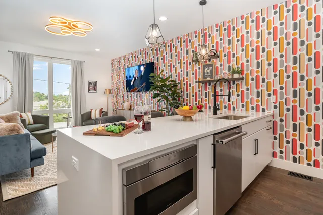 a kitchen that has a stove and a table