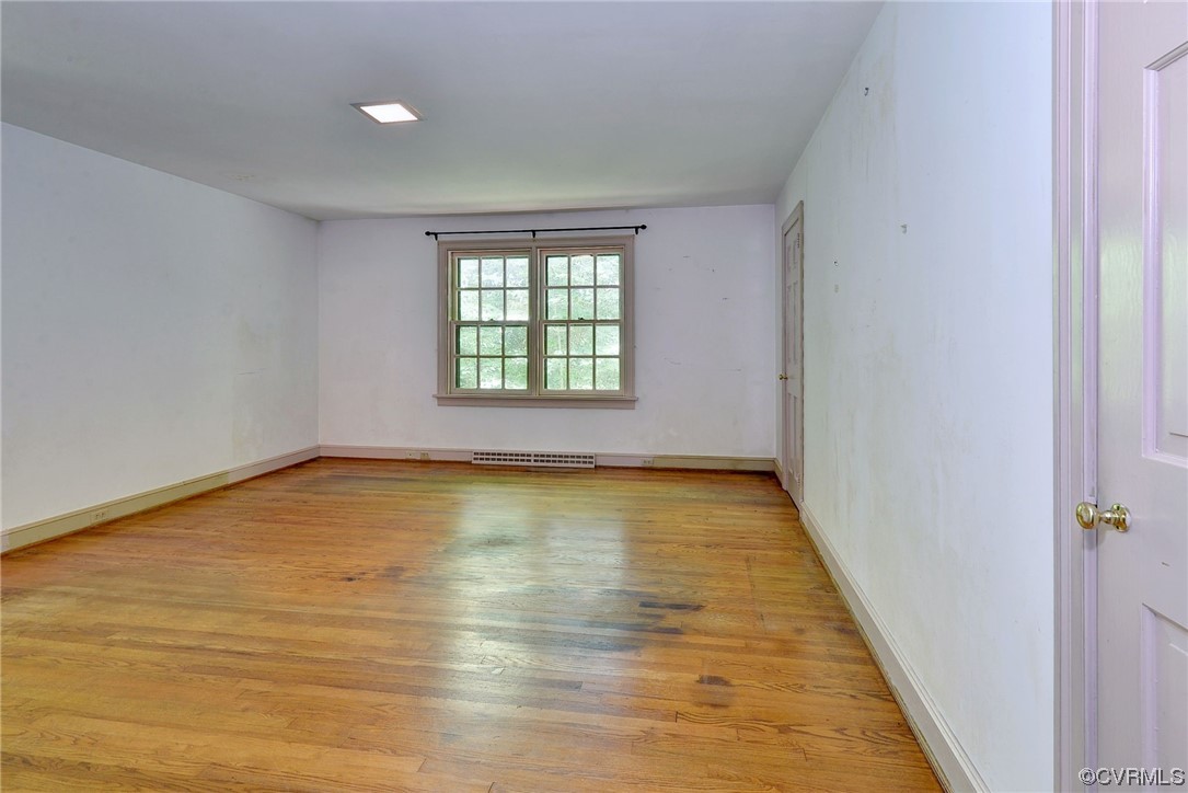 102 Lake Drive Williamsburg, VA 23185 - Photo 16 of 25 a view of an empty room with wooden floor and a window