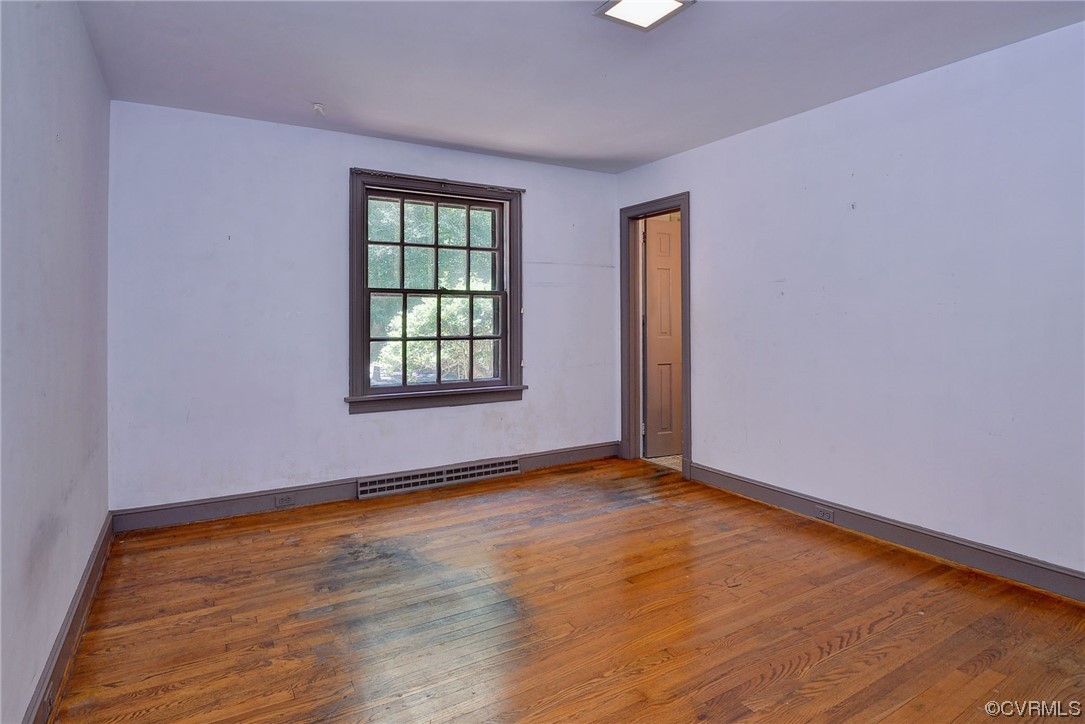 102 Lake Drive Williamsburg, VA 23185 - Photo 18 of 25 a view of an empty room with wooden floor and a window