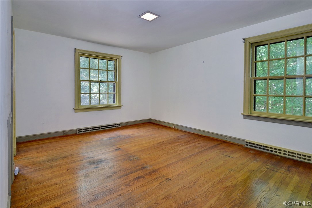 102 Lake Drive Williamsburg, VA 23185 - Photo 21 of 25 an empty room with wooden floor and windows