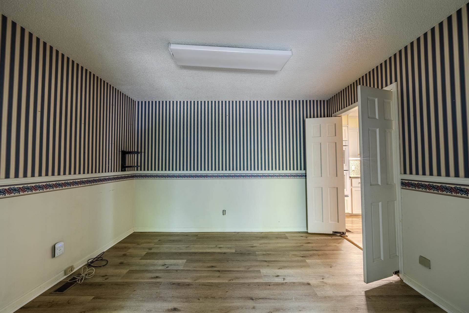 101 Bob Street Selmer, TN 38375 - Photo 11 of 40 a view of an empty room with wooden floor and a window