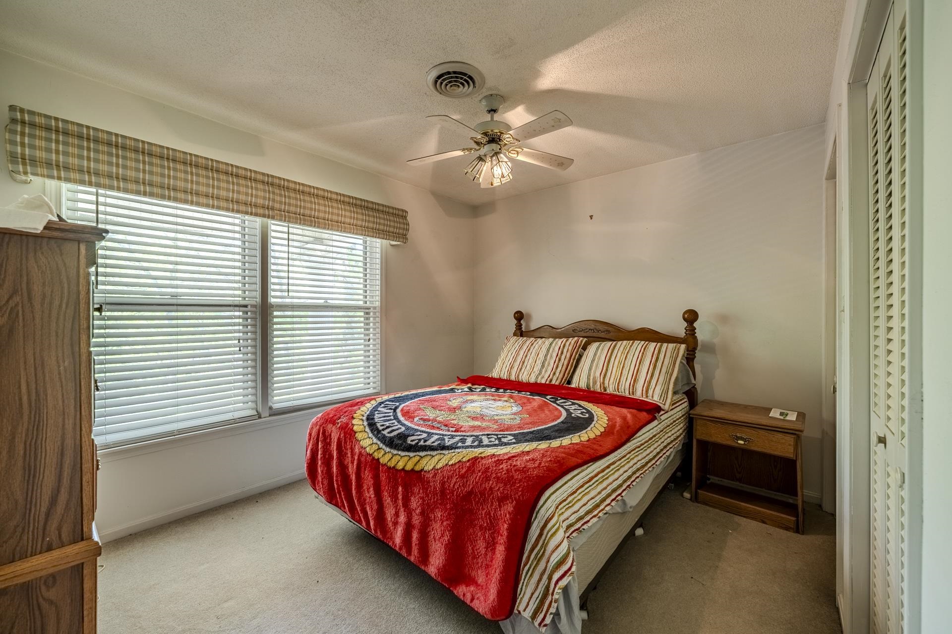 101 Bob Street Selmer, TN 38375 - Photo 24 of 40 a bed sitting in a bedroom next to a window