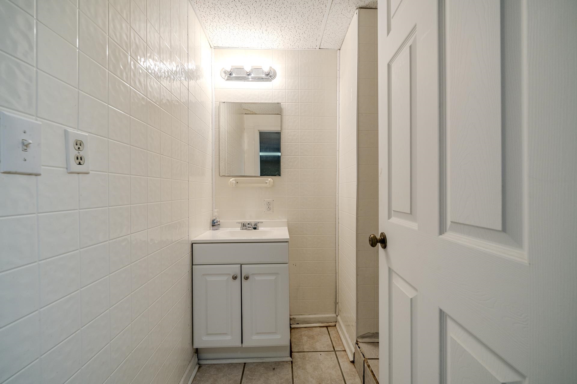 101 Bob Street Selmer, TN 38375 - Photo 30 of 40 a bathroom with a toilet a sink a mirror and vanity