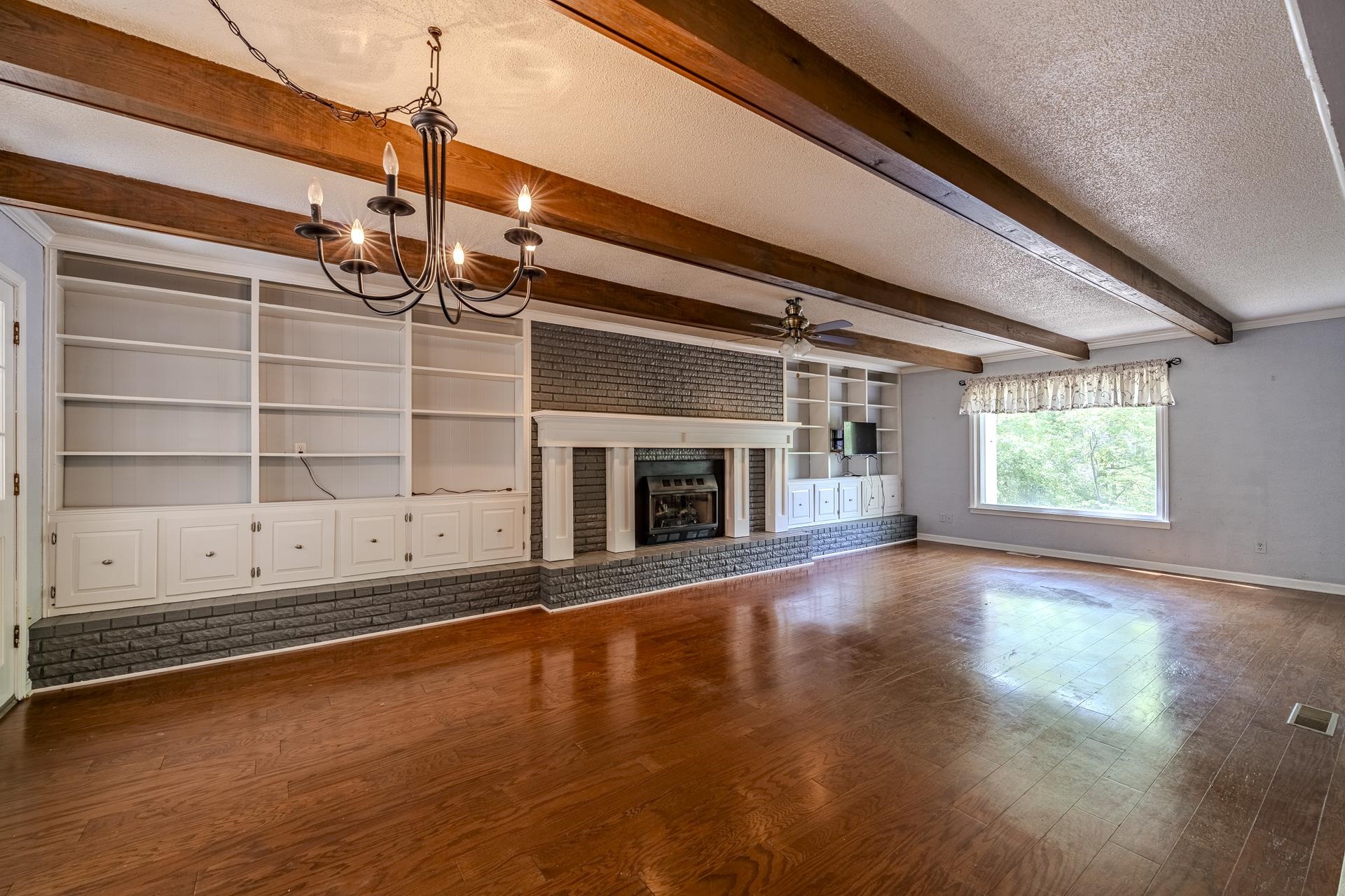 101 Bob Street Selmer, TN 38375 - Photo 5 of 40 a view of an empty room with a fireplace and a window