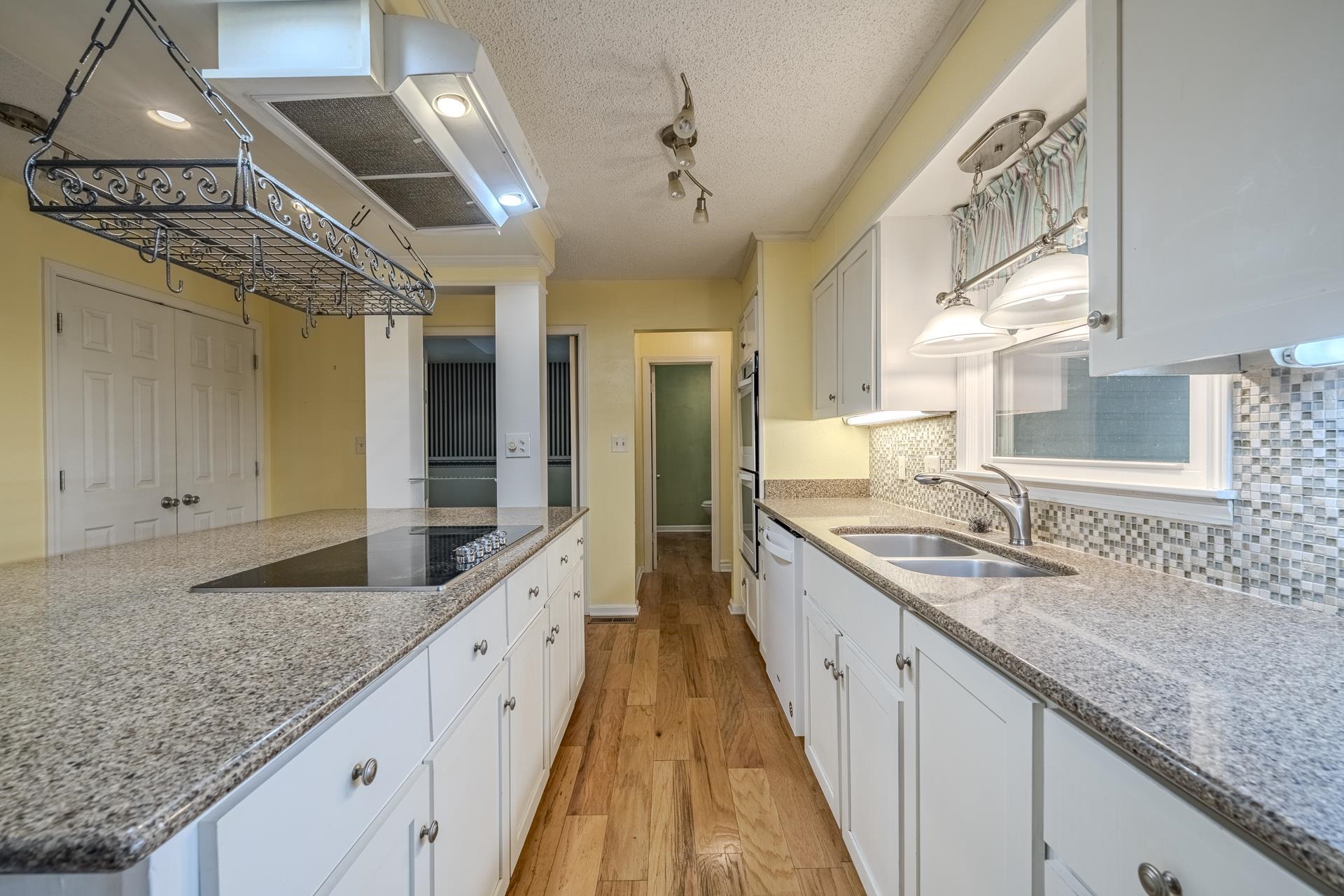101 Bob Street Selmer, TN 38375 - Photo 9 of 40 a large kitchen with granite countertop a sink and cabinets