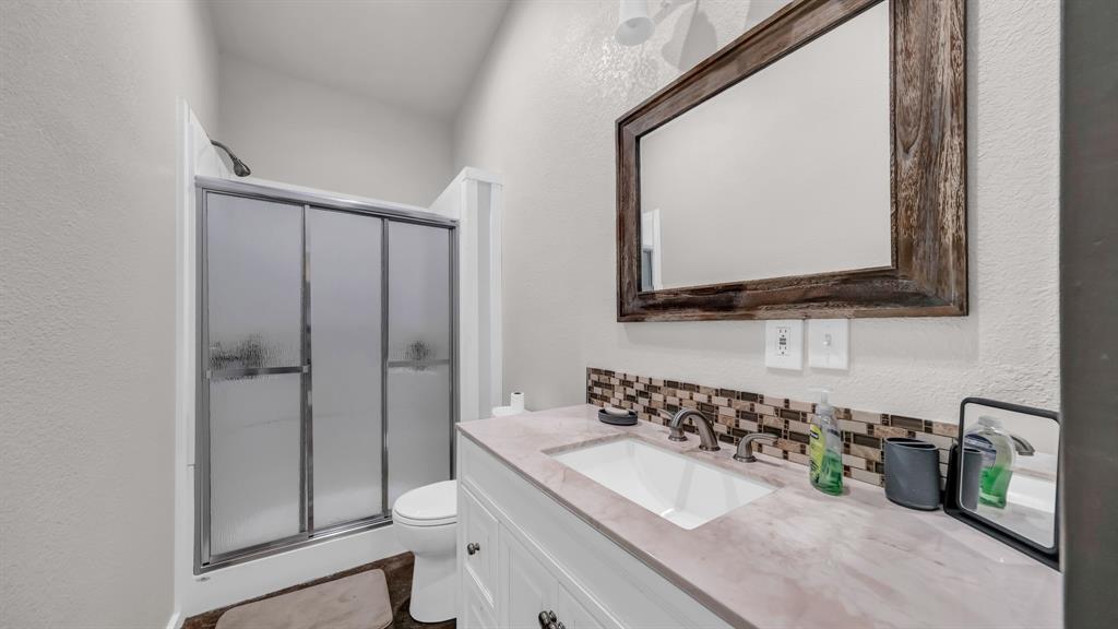 3810 Fairview Road Millsap, TX 76066 - Photo 17 of 25 a bathroom with a double vanity sink mirror and shower