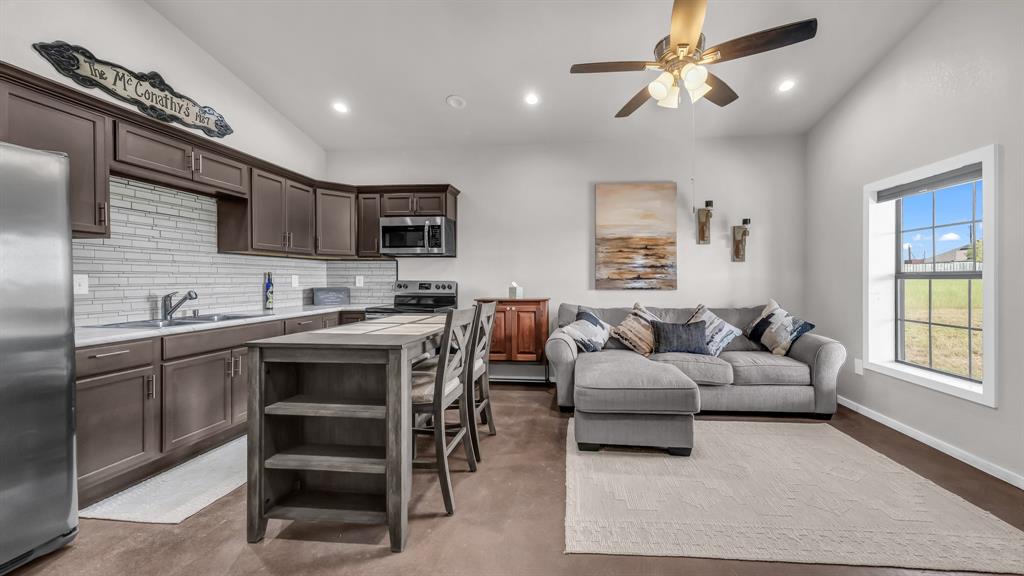 3810 Fairview Road Millsap, TX 76066 - Photo 8 of 25 a living room with stainless steel appliances kitchen island granite countertop furniture and a fireplace