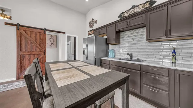 a kitchen that has a sink and a wooden floor