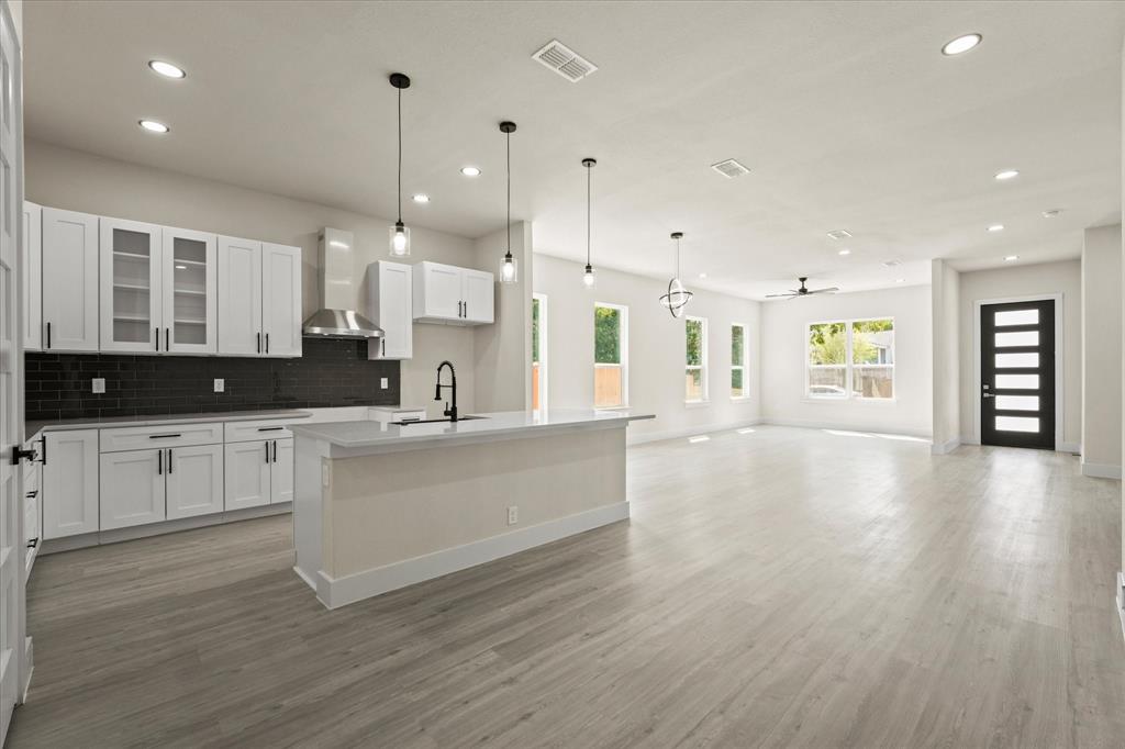 4020 Ranger Drive Dallas, TX 75212 - Photo 27 of 28 a large kitchen with stainless steel appliances kitchen island a large counter top and a wooden floors
