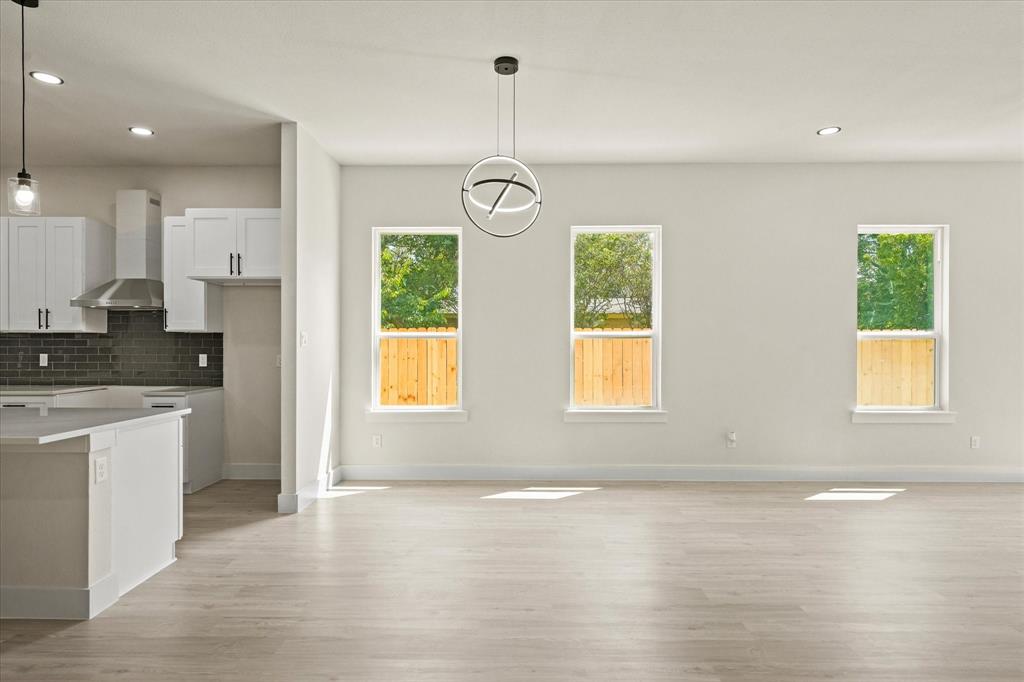 4020 Ranger Drive Dallas, TX 75212 - Photo 9 of 28 an empty room with wooden floor and windows