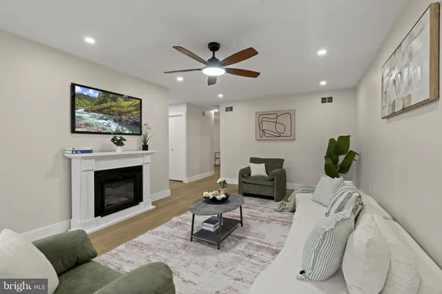 a living room with furniture and a fireplace