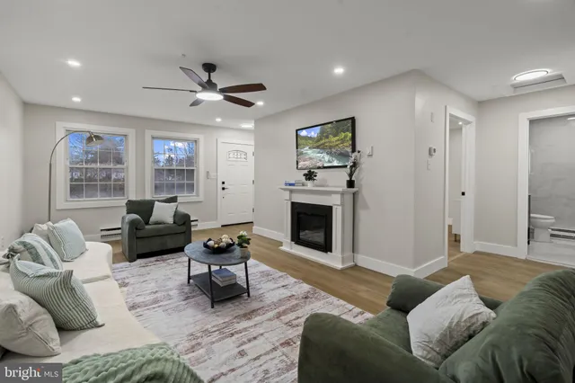 a living room with furniture and a fireplace