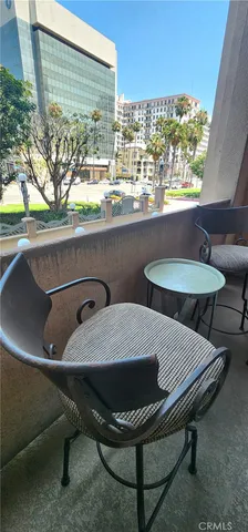 a view of a balcony with table and chairs