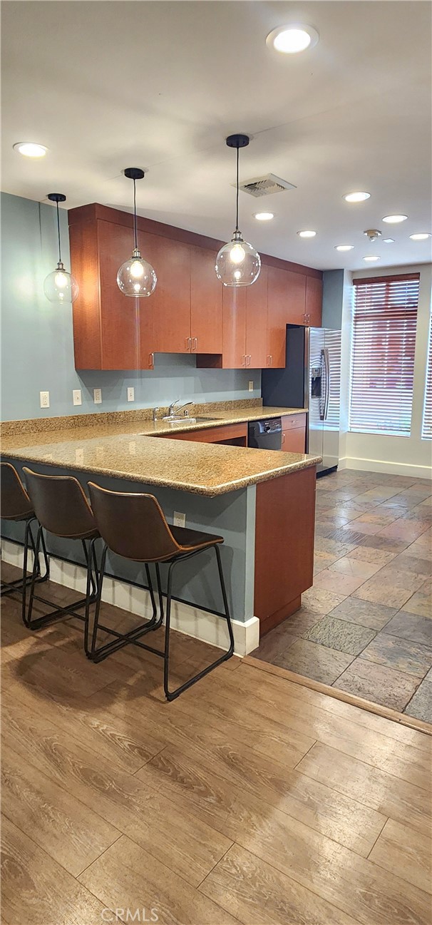 388 East Ocean Boulevard, Unit 206 Long Beach, CA 90802 - Photo 38 of 43 a room with stainless steel appliances lots of wooden furniture