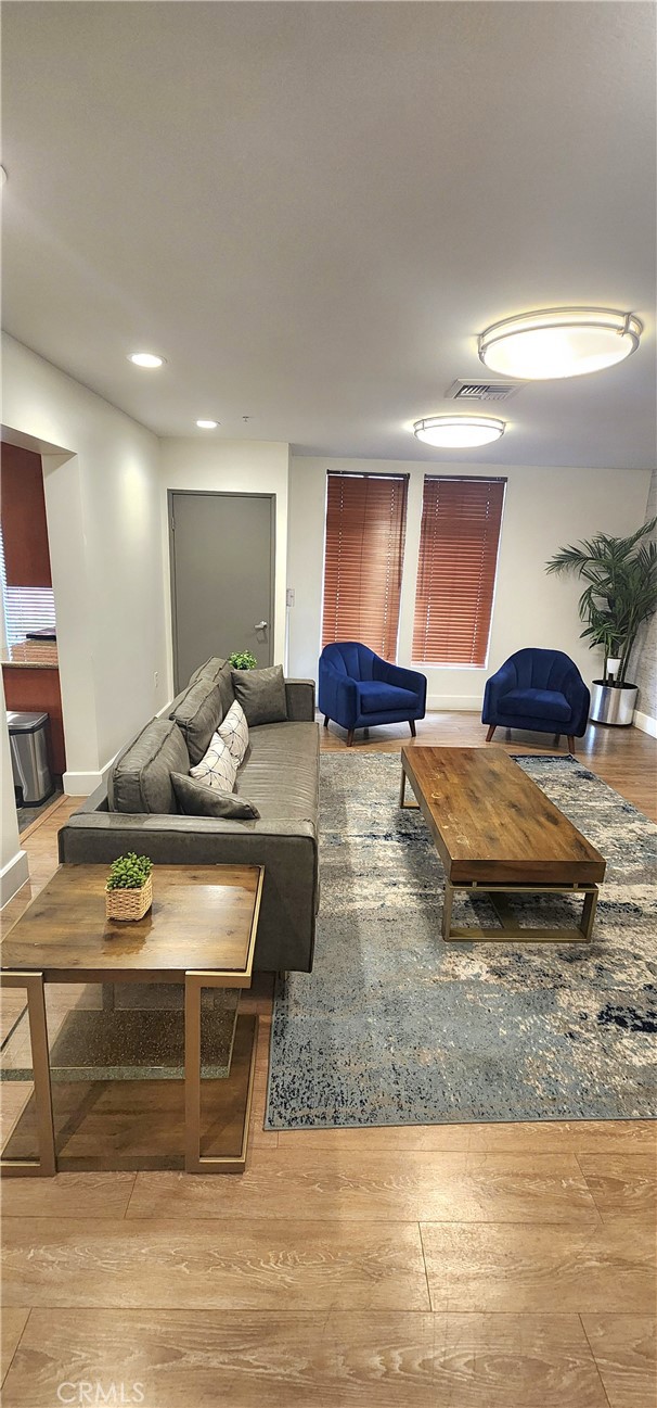 388 East Ocean Boulevard, Unit 206 Long Beach, CA 90802 - Photo 40 of 43 a living room with stainless steel appliances granite countertop furniture and a wooden floor