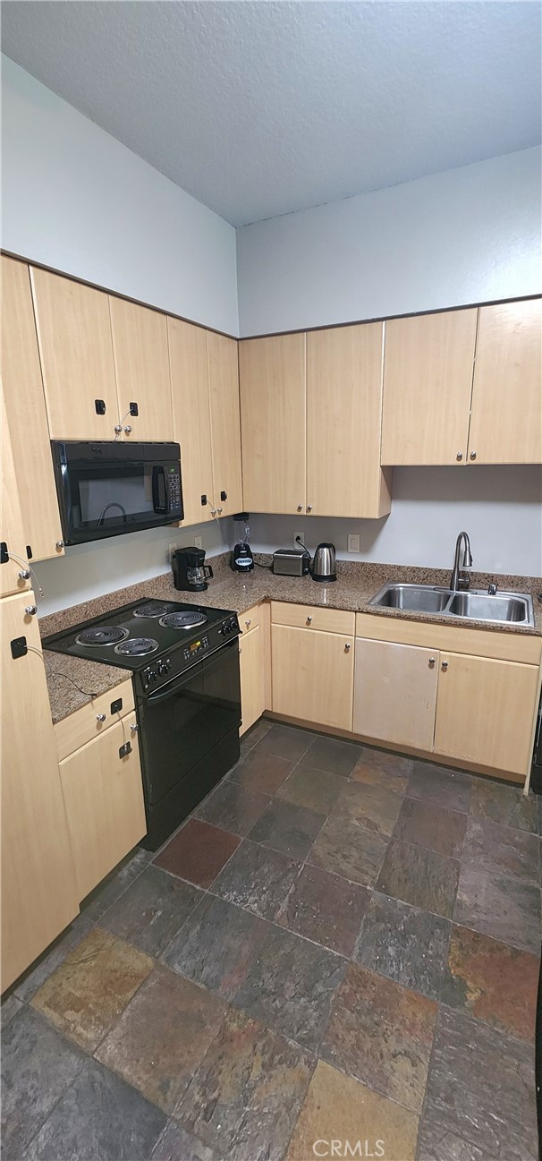 388 East Ocean Boulevard, Unit 206 Long Beach, CA 90802 - Photo 10 of 43 a kitchen with a stove a sink and a refrigerator