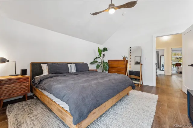 a bedroom with a bed and table chair