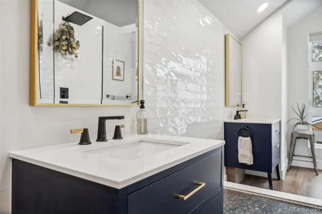 a en suite bathroom with a double vanity sink a mirror and a shower