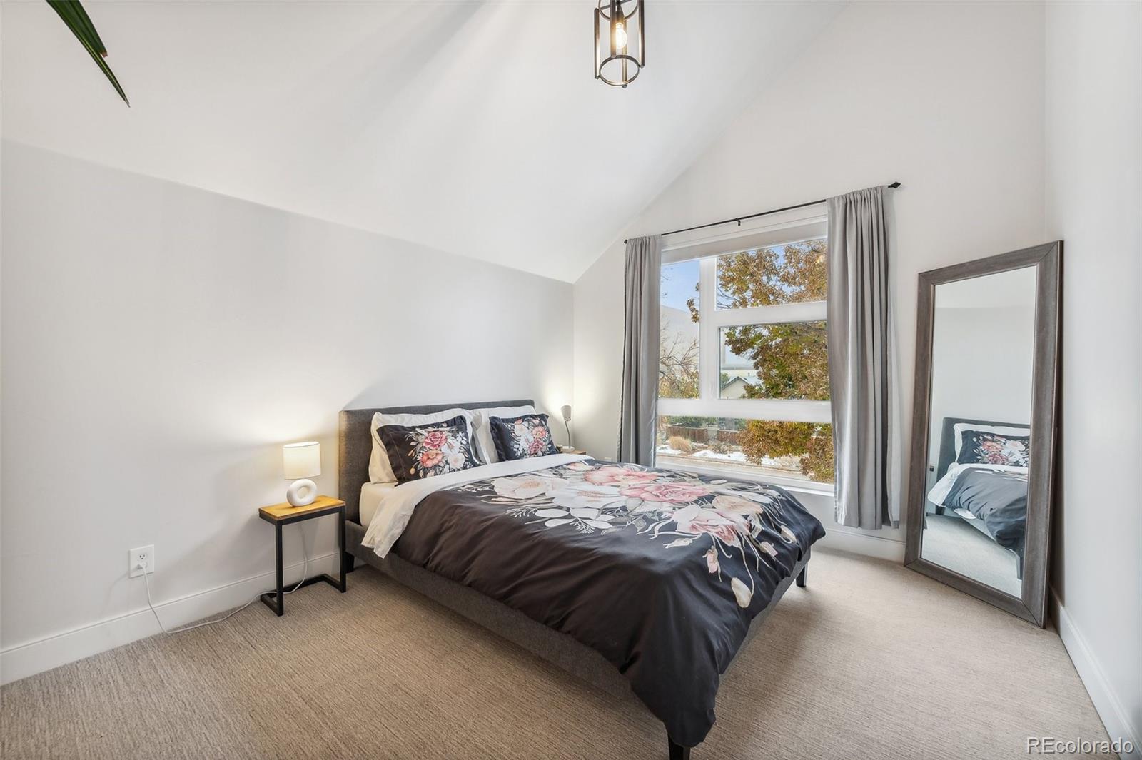 1323 Kalamath Street Denver, CO 80204 - Photo 30 of 40 a bedroom with a bed and a painting on the wall