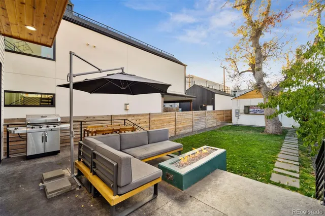 a view of a house with sitting area and a yard