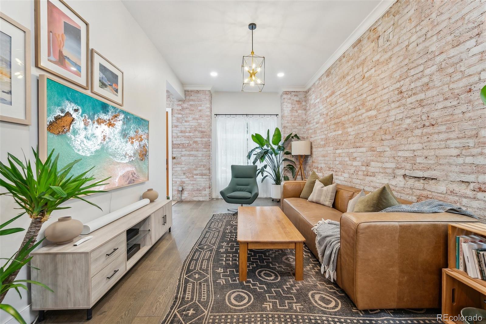 1323 Kalamath Street Denver, CO 80204 - Photo 6 of 40 a living room with furniture and a flat screen tv