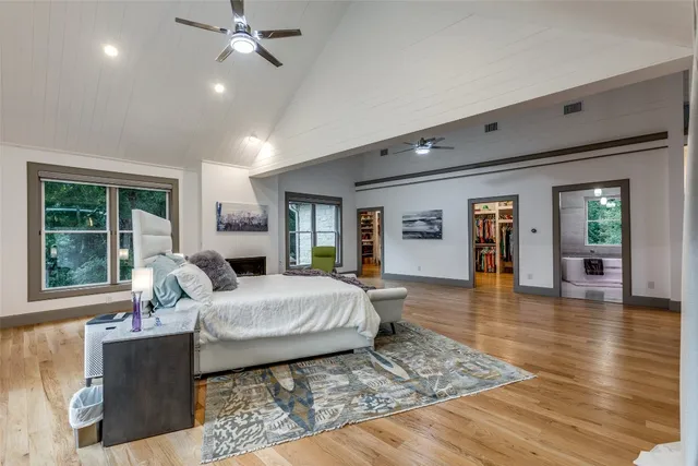 a bedroom with a large bed and a window