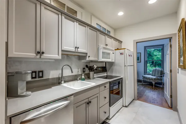 a kitchen with a sink appliances and cabinets