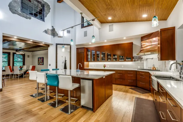 a large kitchen with a table and chairs