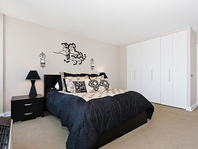 111 East Chestnut Street, Unit 16F Chicago, IL 60611 - Photo 13 of 20 a bedroom with a bed and a night stand